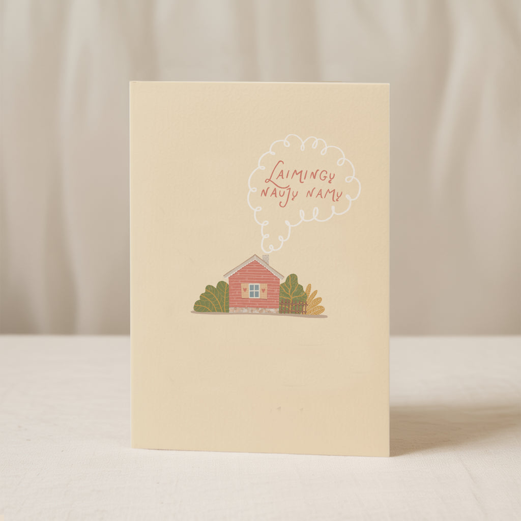 Cozy housewarming greeting card featuring an illustrated cottage with chimney smoke forming the words “Laimingų naujų namų”, warm new home celebration design.