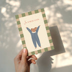 Birthday greeting card featuring a cute mouse with raised arms holding a “Su gimimo diena” sign, whimsical and cheerful birthday card design.