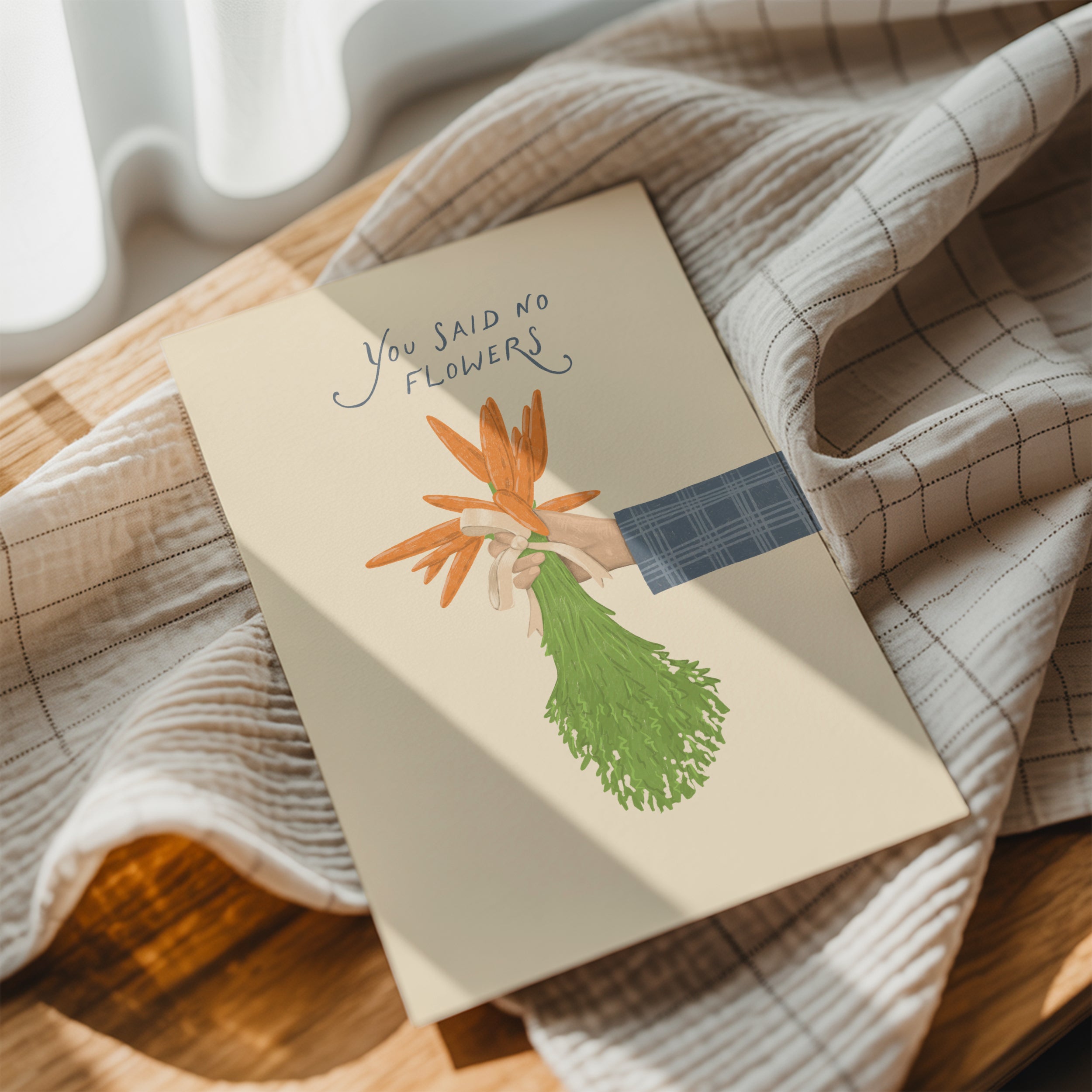 Funny wedding greeting card showing a hand holding a bouquet of carrots instead of flowers with the text “You said no flowers”, humorous minimalist wedding design.