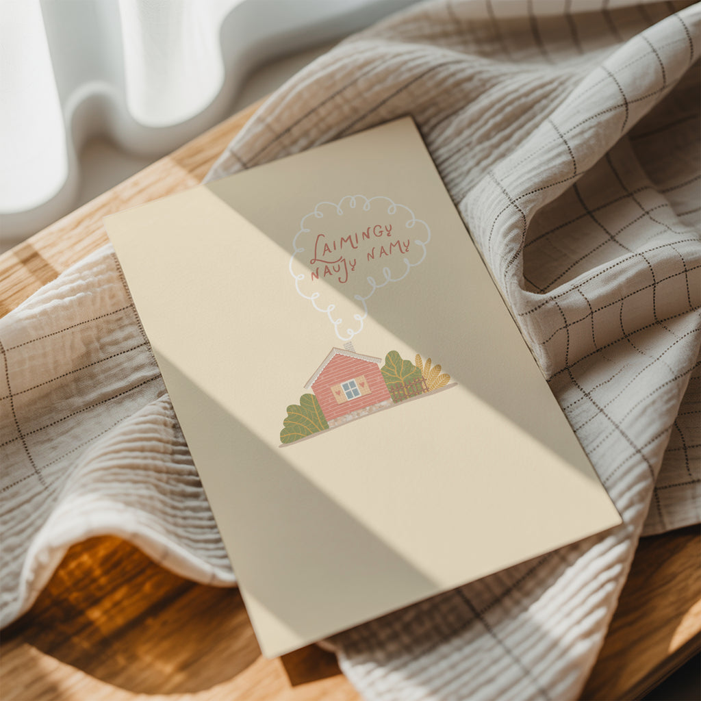 Cozy housewarming greeting card featuring an illustrated cottage with chimney smoke forming the words “Laimingų naujų namų”, warm new home celebration design.