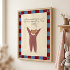 Cute storybook mouse wearing a striped outfit, standing with arms raised and pointing toward the quote "How wonderful life is now you're in the world". Beige background with a blue and burgundy gingham-style border, printable nursery wall art.