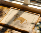 Minimalist safari-style nursery wall art featuring a Scandinavian lion illustration drawn on a soft beige background, framed with a decorative wavy border, printable digital artwork designed for safari-themed kids room, nursery, or playroom decor, creating a calm, modern, and cozy interior atmosphere.