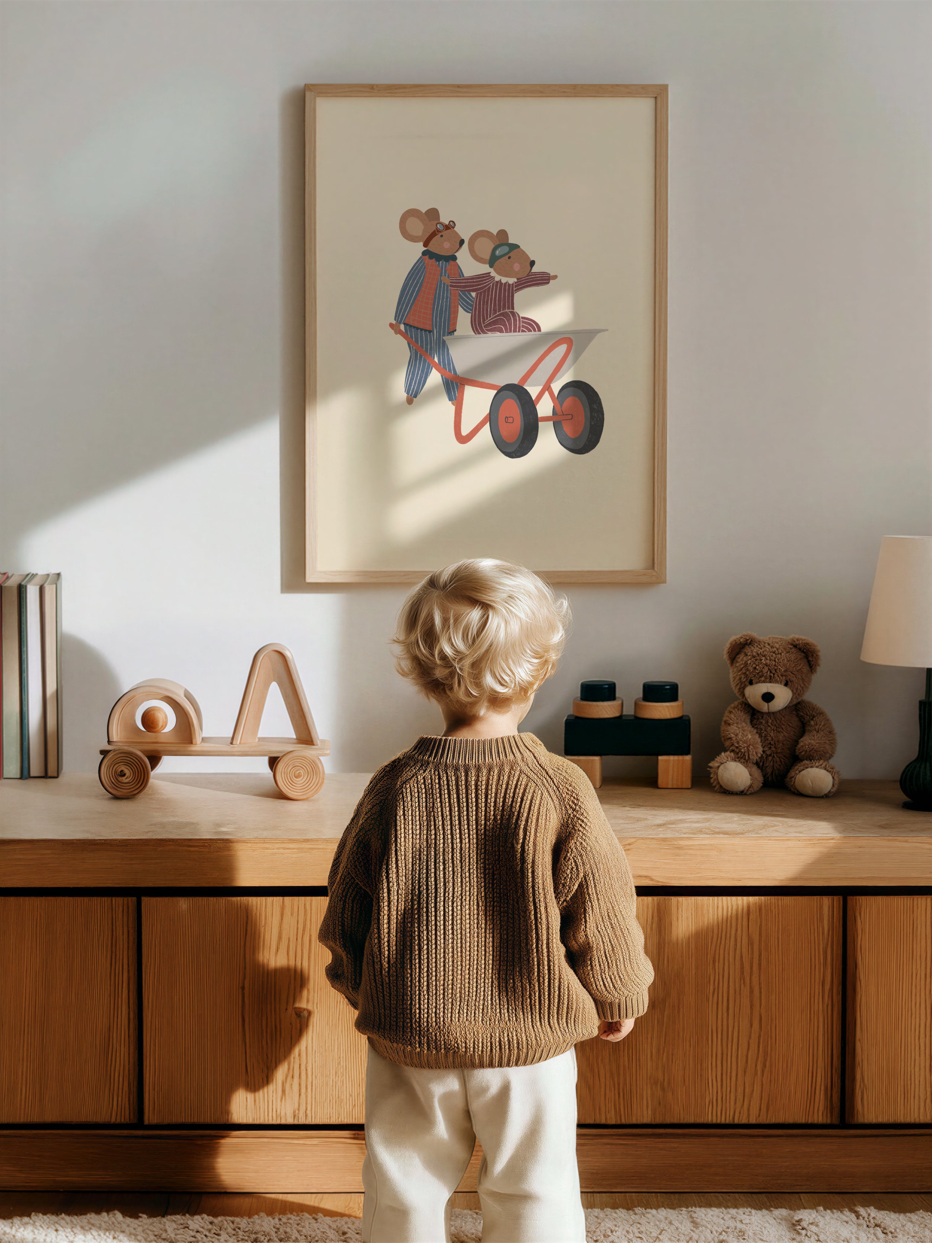 Whimsical nursery wall art featuring two mice wearing aviator goggles, one pushing a wheelbarrow while the other rides inside with arms outstretched, on a soft beige background.