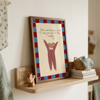 Cute storybook mouse wearing a striped outfit, standing with arms raised and pointing toward the quote "How wonderful life is now you're in the world". Beige background with a blue and burgundy gingham-style border, printable nursery wall art.