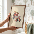 Whimsical nursery wall art featuring two mice wearing aviator goggles, one pushing a wheelbarrow while the other rides inside with arms outstretched, on a soft beige background.