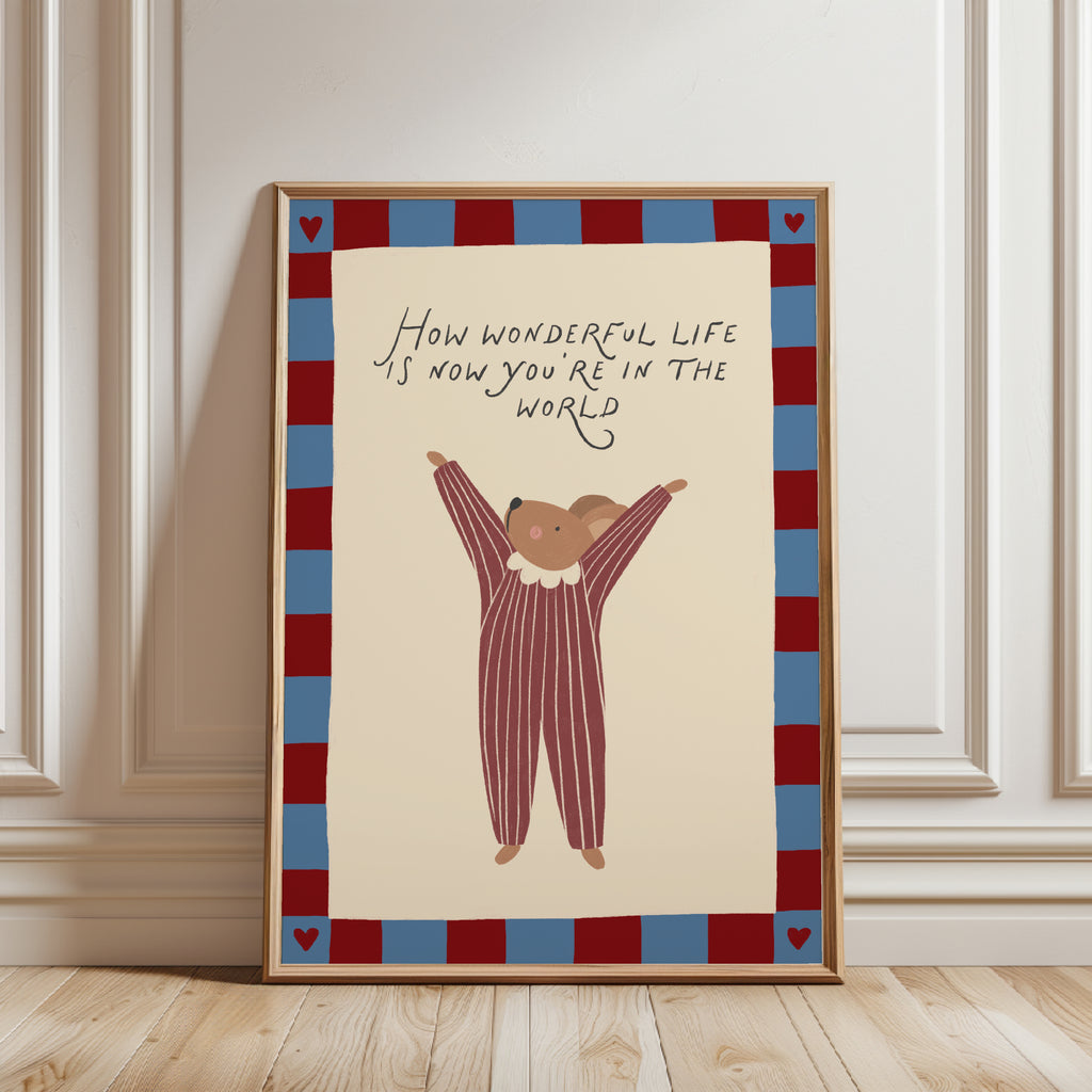 Cute storybook mouse wearing a striped outfit, standing with arms raised and pointing toward the quote "How wonderful life is now you're in the world". Beige background with a blue and burgundy gingham-style border, printable nursery wall art.