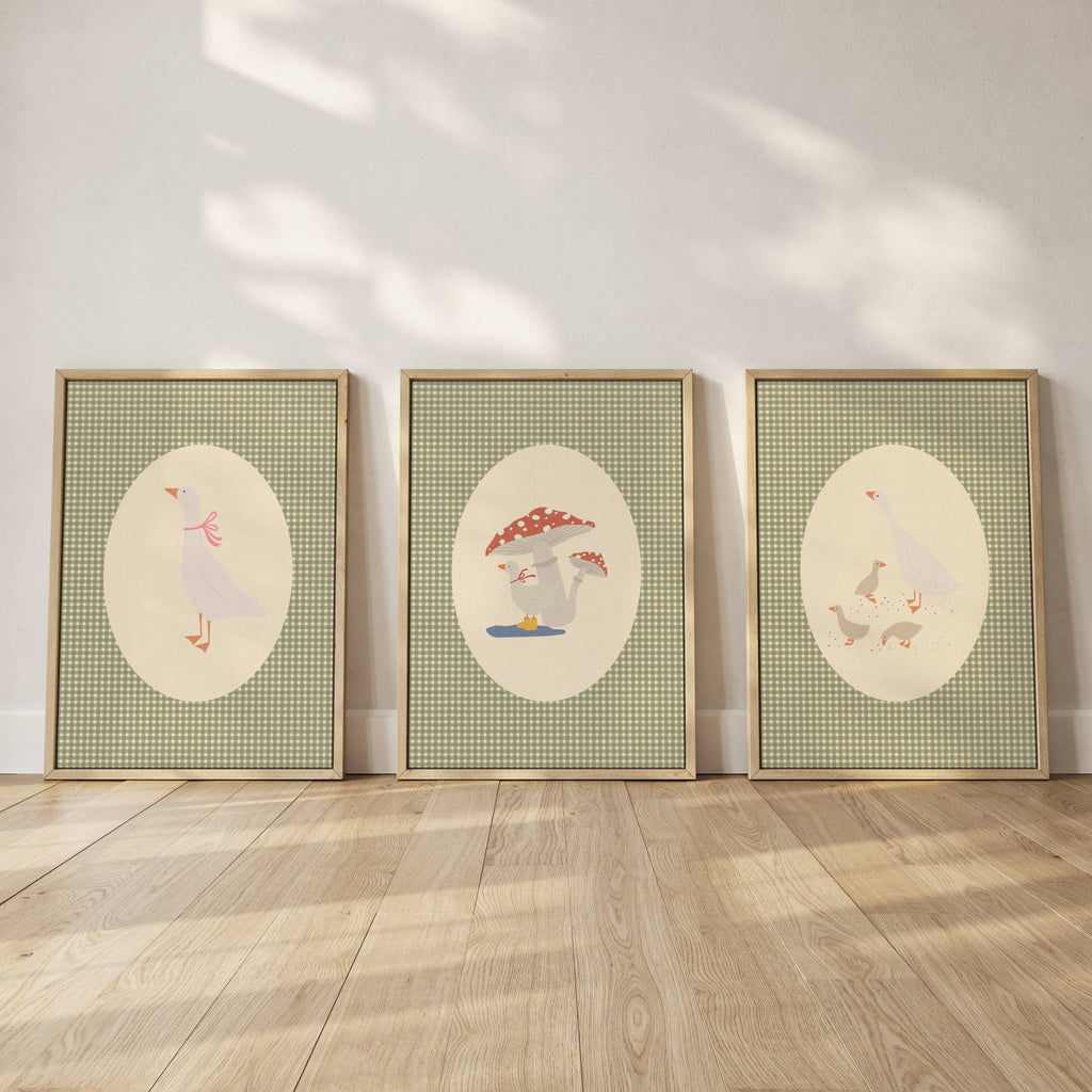 Set of three matching children’s posters featuring cute duck illustrations in oval frames on a green gingham background, in a soft classic style