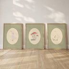 Set of three matching children’s posters featuring cute duck illustrations in oval frames on a green gingham background, in a soft classic style